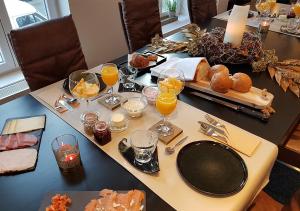 a table with breakfast foods and glasses of orange juice at Hotel Goodnight Antwerp in Antwerp