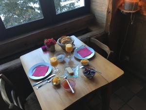 a table with plates of food and glasses of orange juice at La Chicholiere in Gresse-en-Vercors
