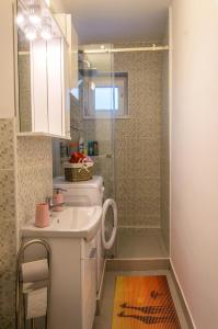 a small bathroom with a sink and a shower at Bike-Friendly Apartment in Timişoara +20 photos