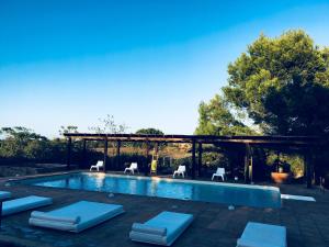a swimming pool with chairs at Daniela in Sant Francesc Xavier