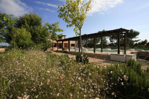 a garden with a pavilion in the background at Daniela in Sant Francesc Xavier