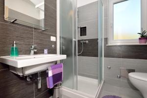 a bathroom with a sink and a shower and a toilet at Apartment Andrea in Sveta Marina
