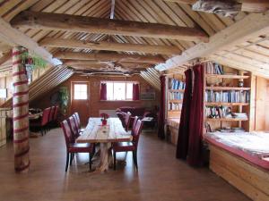 a dining room with a wooden table and chairs at Metsatu Valge Elevandi puhkemaja in Otepää