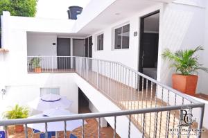 a balcony of a white house with plants at Hotel Plaza Colonial in Valledupar +17 photos