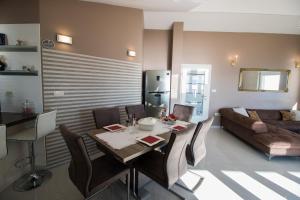 a living room with a table and a couch at Incantesimo luxury penthouse in Mimice