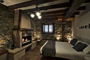 Un dormitorio con una cama y una chimenea. en Urdaibai Etxea, en Ea