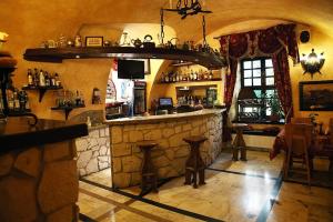 a bar in a restaurant with a stone wall at Dwór Anna in Ciecierzyn
