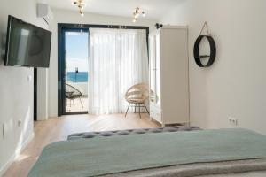 een slaapkamer met een bed en uitzicht op de oceaan bij La Concha Boutique Apartments - Adults Only in Arrecife