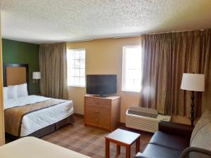 a hotel room with a bed and a tv at Extended Stay America Suites - Jacksonville - Salisbury Rd - Southpoint in Jacksonville