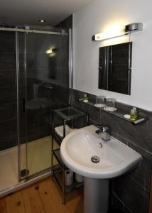 a bathroom with a sink and a shower at The Crown Inn in West Down