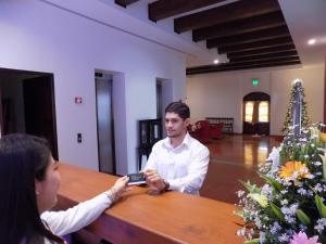 a man sitting at a table talking to a woman at Hotel La Recolección in León