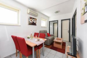 uma sala de estar com uma mesa e um sofá em Apartment Katia em Zadar