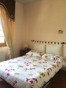 a bedroom with a bed with a floral bedspread at Casa Paradiso in Anacapri