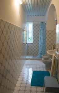 a bathroom with two sinks and two toilets at Casa Paradiso in Anacapri