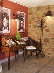 a room with a table and a chair and a desk at Los Canteros in Golmayo