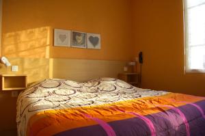 a bedroom with a bed in a room at Hôtel de Tessé in Bagnoles de l'Orne