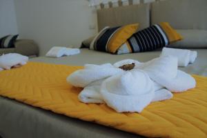 a pile of white towels on a bed at Oltre la Costa in Agerola