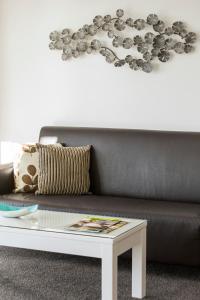 a living room with a couch and a coffee table at Oaks Mackay Rivermarque Hotel in Mackay