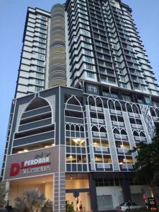 a tall building with a sign in front of it at D'Perdana Apartment 2 in Kota Bharu