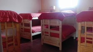 a group of four bunk beds in a room at Piedra Blanca Backpackers Hostel in Uyuni