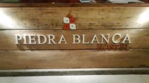 a sign on the wall of a pizza blanca house at Piedra Blanca Backpackers Hostel in Uyuni