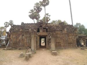 a stone building with a doorway in a field at SunRise Villa in Kampong Cham