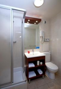 a bathroom with a shower and a sink and a toilet at Classics Hotel Bastille in Paris
