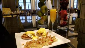 a plate of food with eggs and potatoes on a table at Warwick Allerton Chicago in Chicago
