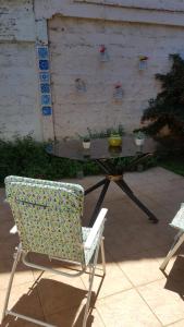 a chair and a table with a bowl on it at Hospedaje Myrtha in Temuco