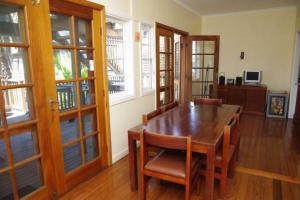 a dining room with a wooden table and chairs at Berry, 16 East Street in Crescent Head