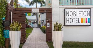 a building with a sign on the side of it at Nobleton Hotel in Fort Lauderdale