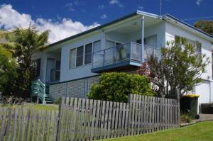 a white house with a fence in front of it at Clareview, 8 Korogora Street in Crescent Head