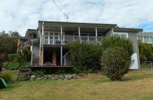 a house with a large porch and a balcony at Awesome View, 4 View Street in Crescent Head