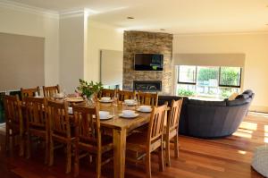 a dining room with a table and a couch at 20 Mountbatten Ave, Bright in Bright