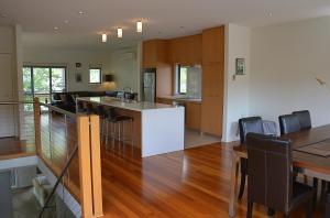 a kitchen and dining room with a table and a counter at The Track - beautiful townhouse in Bright in Bright