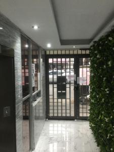 an entrance to a building with glass doors and a plant at Hostal Ciudad de Mexico in Mexico City