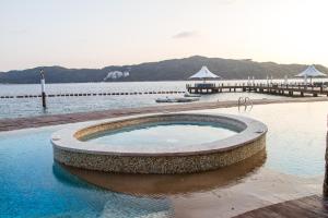a swimming pool in the middle of a body of water at B Esmeralda Pichilingue PentHouse in Acapulco