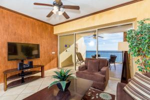 a living room with a ceiling fan and a television at Rocky Point Sonoran Resorts in Puerto Peñasco