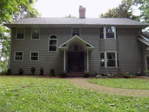 una casa gris con una puerta delantera y un patio en StoneWall House Lakeside Suite, en Lake Elmo