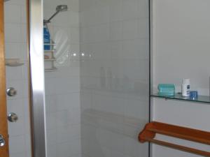 a shower with a glass door in a bathroom at Rocky Beach Cottage 26 Pacific Drive in Port Macquarie