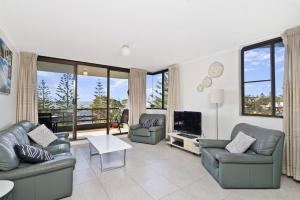 a living room with two couches and a television at Sundial 503 8-10 Hollingworth Street in Port Macquarie