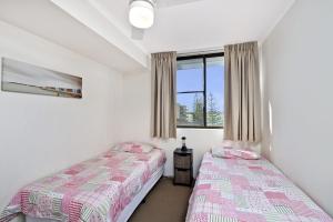 a bedroom with two beds and a window at Sundial 503 8-10 Hollingworth Street in Port Macquarie