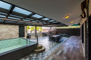 a house with a swimming pool and a patio at Melinda Resort in Hengchun