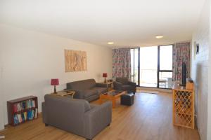 a living room with two couches and a tv at Beachpark 10 58 Pacific Drive in Port Macquarie