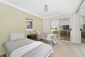 a bedroom with two beds and a window at Westport Palms 14 Buller Street in Port Macquarie