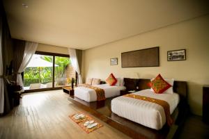 a hotel room with two beds and a couch at Senetan Villas and Spa Resort in Payangan +95 photos