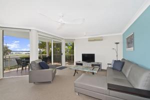 a living room with a couch and a table at Westport Palms 14 Buller Street in Port Macquarie