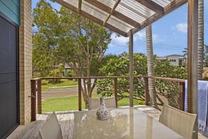 a patio with a table and chairs on a porch at Amara 6 Wesley Avenue in Port Macquarie