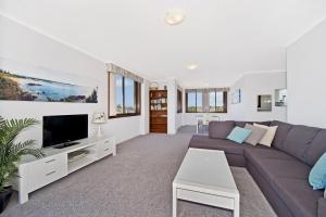 a living room with a couch and a tv at Akuna 18 6 Joffre Street in Port Macquarie