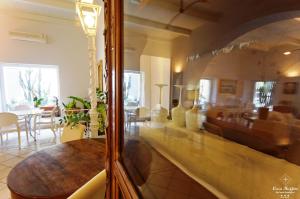 a dining room with a table and a living room at B&B Casa Ruffino in Balestrate